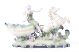 A Continental porcelain chariot group, circa 1900, in the style of Royal Dux,