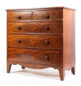 A Victorian flame mahogany chest of two short over three long drawers with shaped skirt raised on