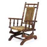 An Edwardian oak child's rocking chair, with turned reeded spindles and uprights,