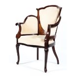 An Edwardian inlaid mahogany elbow chair with padded side arms and back rest the overstuffed seat