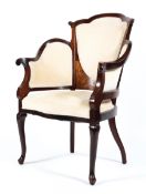 An Edwardian inlaid mahogany elbow chair with padded side arms and back rest the overstuffed seat