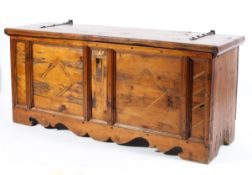 A large pine coffer with 17th century style hinges, with panel front,