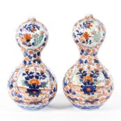 A pair of 19th century Japanese Imari double gourd shaped vases decorated with reserves of