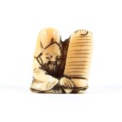 A small Meiji period marine ivory netsuke of Fukurokuju seated in a patterned robe holding an