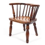A 19th century child's ash and elm elbow chair with spindle back,