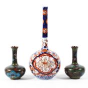 A small 19th century Japanese Imari bottle vase and a pair of small cloisonne vases,