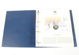 A folder containing The Queen's Golden Jubilee Coin Cover Collection
