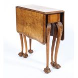 An early 20th century walnut drop leaf side table raised on carved cabriole supports to ball and