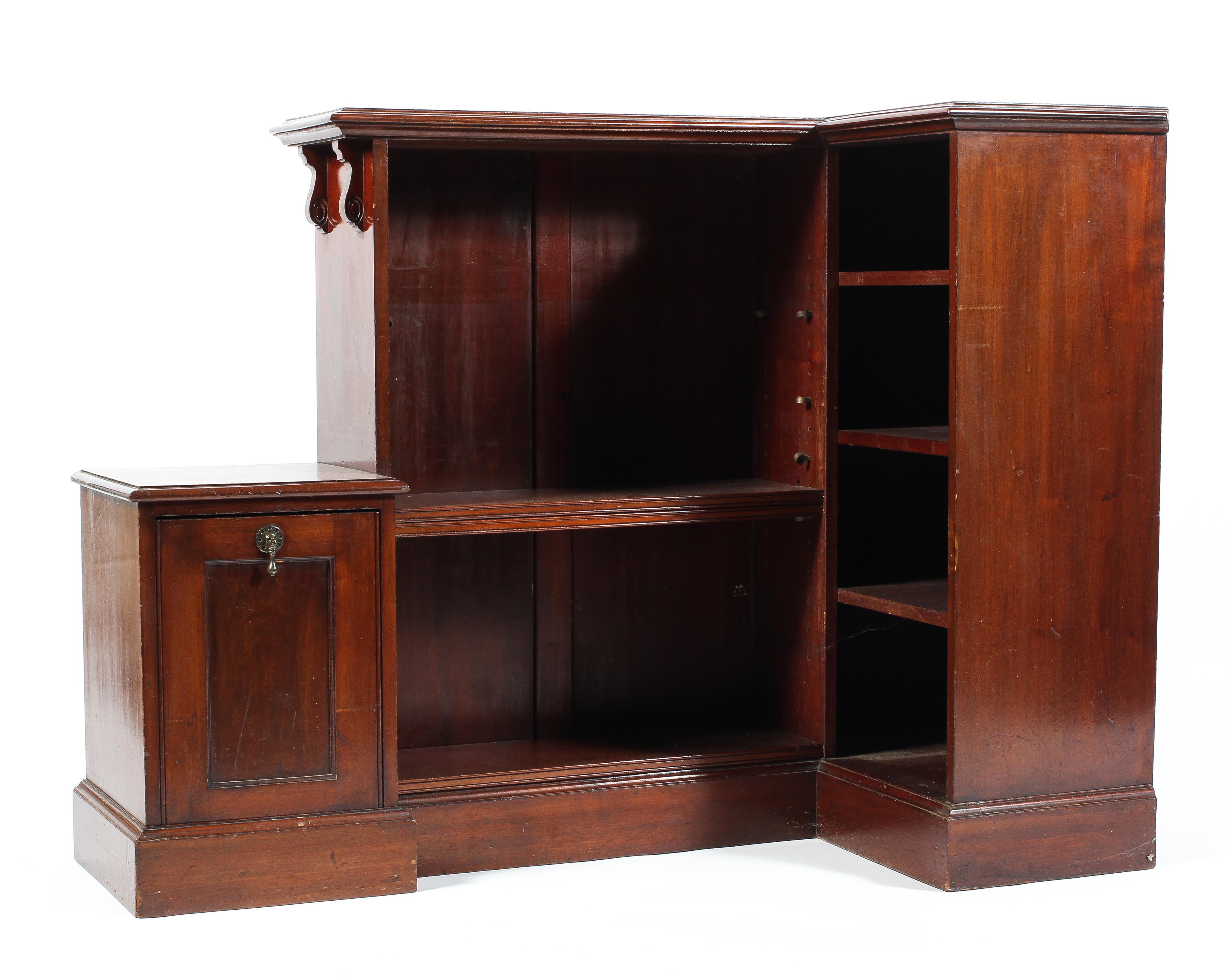 An Edwardian mahogany corner bookcase of three fixed shelves and three adjustable with attached