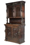 An early 21st century Gothic style oak court cupboard with all over carved decoration and lion head