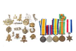 An assortment of military cap badges,