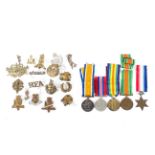 An assortment of military cap badges,