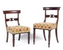 Four mid-19th century mahogany dining chairs, each top rail carved with scrolling leaves,