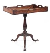 A Georgian mahogany tilt top butlers tray/table raised on a turned baluster column to a tripod