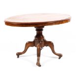 A Victorian inlaid walnut loo table, raised on a turned column to a quadrofoil base,