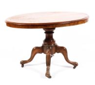 A Victorian inlaid walnut loo table, raised on a turned column to a quadrofoil base,