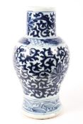 A large Chinese blue and white vase decorated with lotus flowers and leaves to the body below