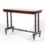 A Victorian rosewood side table raised on turned double columns and turned stretchers to short ball