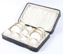 A Mintons cased set of six coffee cans and saucers in original presentation case