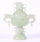 A Chinese pale green hardstone incense burner with pierced and carved dragon and ring lid finial