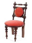 A Victorian mahogany child's upholstered chair with turned carved frame and overstuffed seat raised