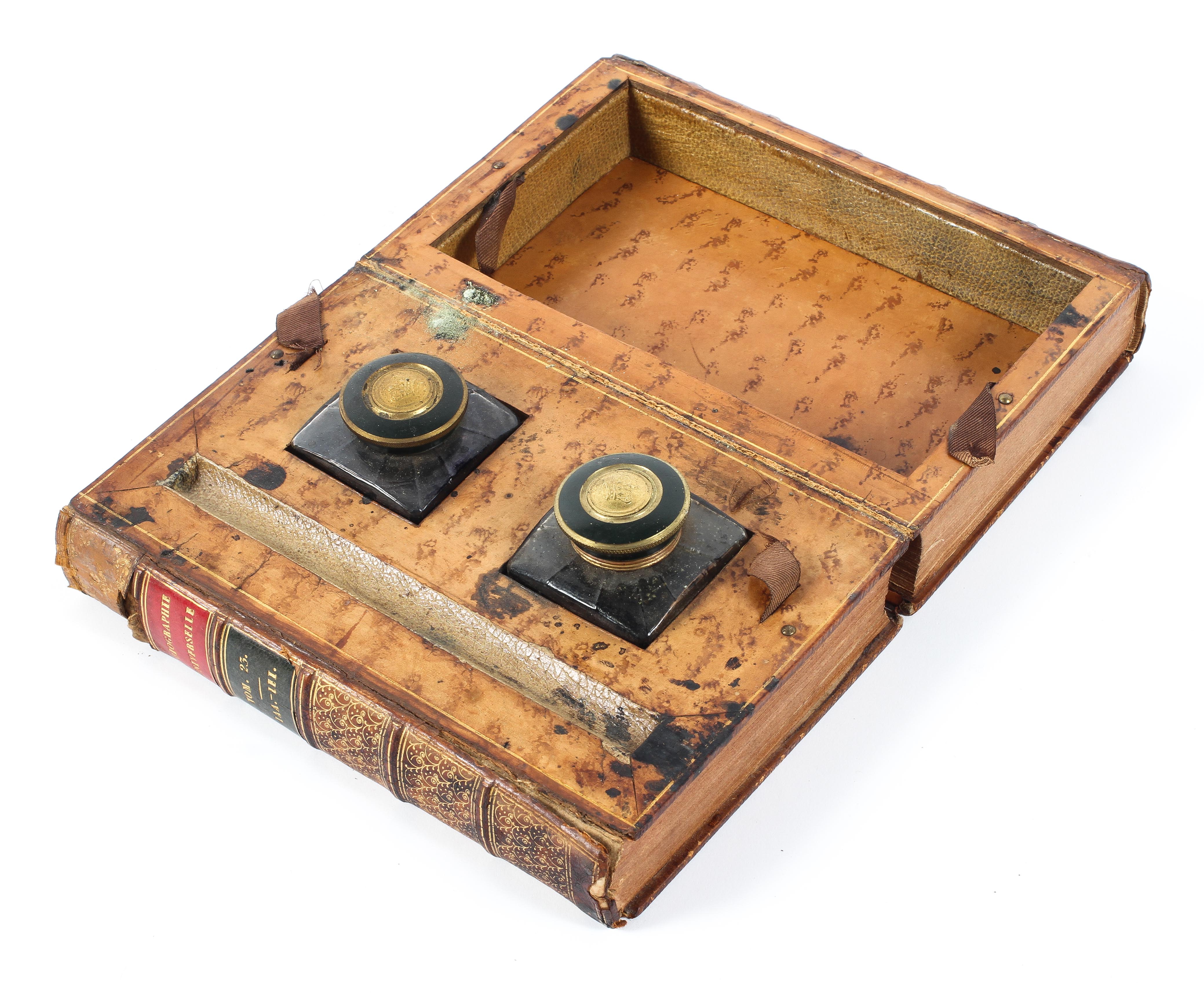 A 19th century twin inkwell in the form of a leather bound book titled Biographie Universelle,