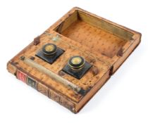 A 19th century twin inkwell in the form of a leather bound book titled Biographie Universelle,