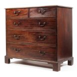 An Edwardian mahogany chest of two short over three long graduating drawers raised on bracket