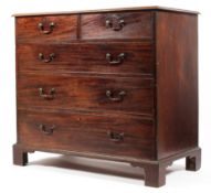 An Edwardian mahogany chest of two short over three long graduating drawers raised on bracket