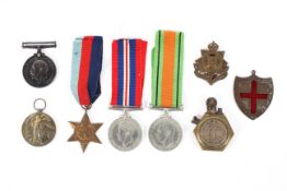 An assortment of WWI & WWII medals including a trench art style lighter