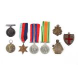 An assortment of WWI & WWII medals including a trench art style lighter