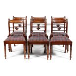 A set of six Regency mahogany dining chairs with carved splat and drop in seat,
