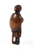 An 18th/19th century wood netsuke of a man standing with his head raised,