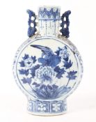 A Chinese Qing dynasty blue and white moon flask decorated with birds and peony flowers,