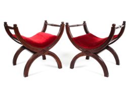 A pair of mahogany framed salanarola upholstered in red velvet raised on arched x frame reeded