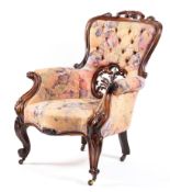 A Victorian mahogany framed button back elbow chair with lower perced carved splat with out