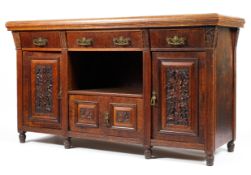 A 20th century teak sideboard of large formation with three drawers above an open well and a small