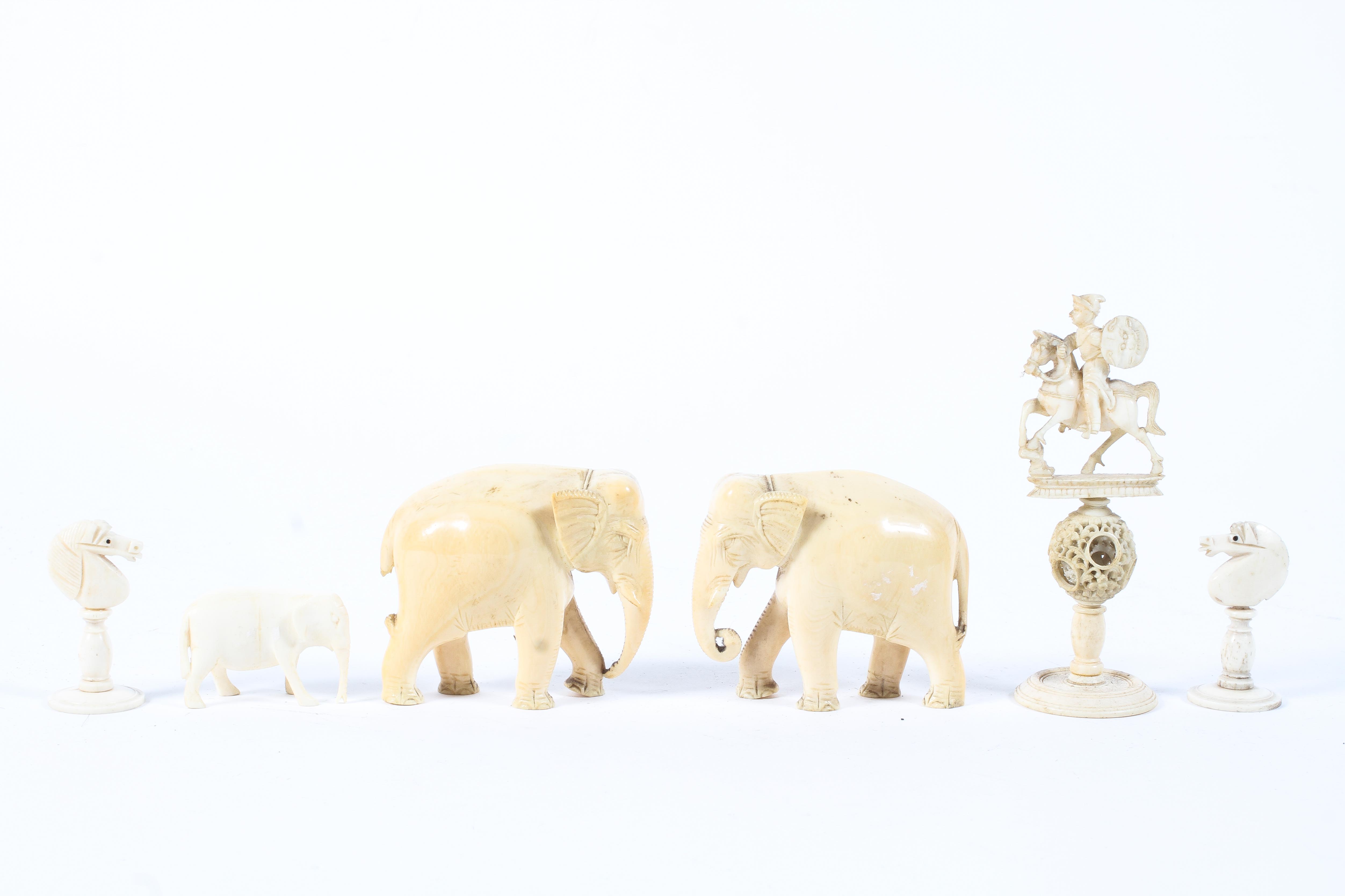 An assortment of late 19th/early 20th century carved ivory including, a pair of elephants,