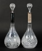 A pair of Continental sIlver topped glass decanters,