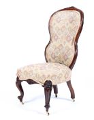 A Victorian mahogany hooped upholstered bedroom chair with overstuffed seat raised on cabriole and