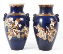 A pair of late 19th/early 20th century large Japanese vases decorated with groups of warriors on a
