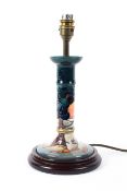 A Moorcroft blue-ground lamp base, on turned wooden base, electrified,