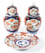 Pair of late 19th century Japanese Imari baluster vases and covers and a similar plate,