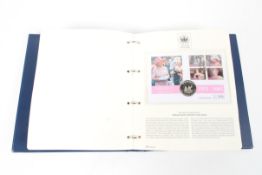 A folder containing The Queen's Golden Jubilee Coin First Day covers