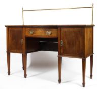 An Edwardian inlaid mahogany serpentine fronted sideboard with brass gallery rail,