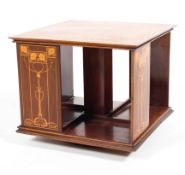 An Art Nouveau inlaid mahogany table top revolving bookcase with four compartments,