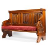 An early 20th century church pew with linenfold panel back rest and carved side,
