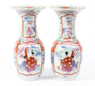 A pair of 19th century Japanese vases with fluted rims decorated with figures, foliage and flowers,