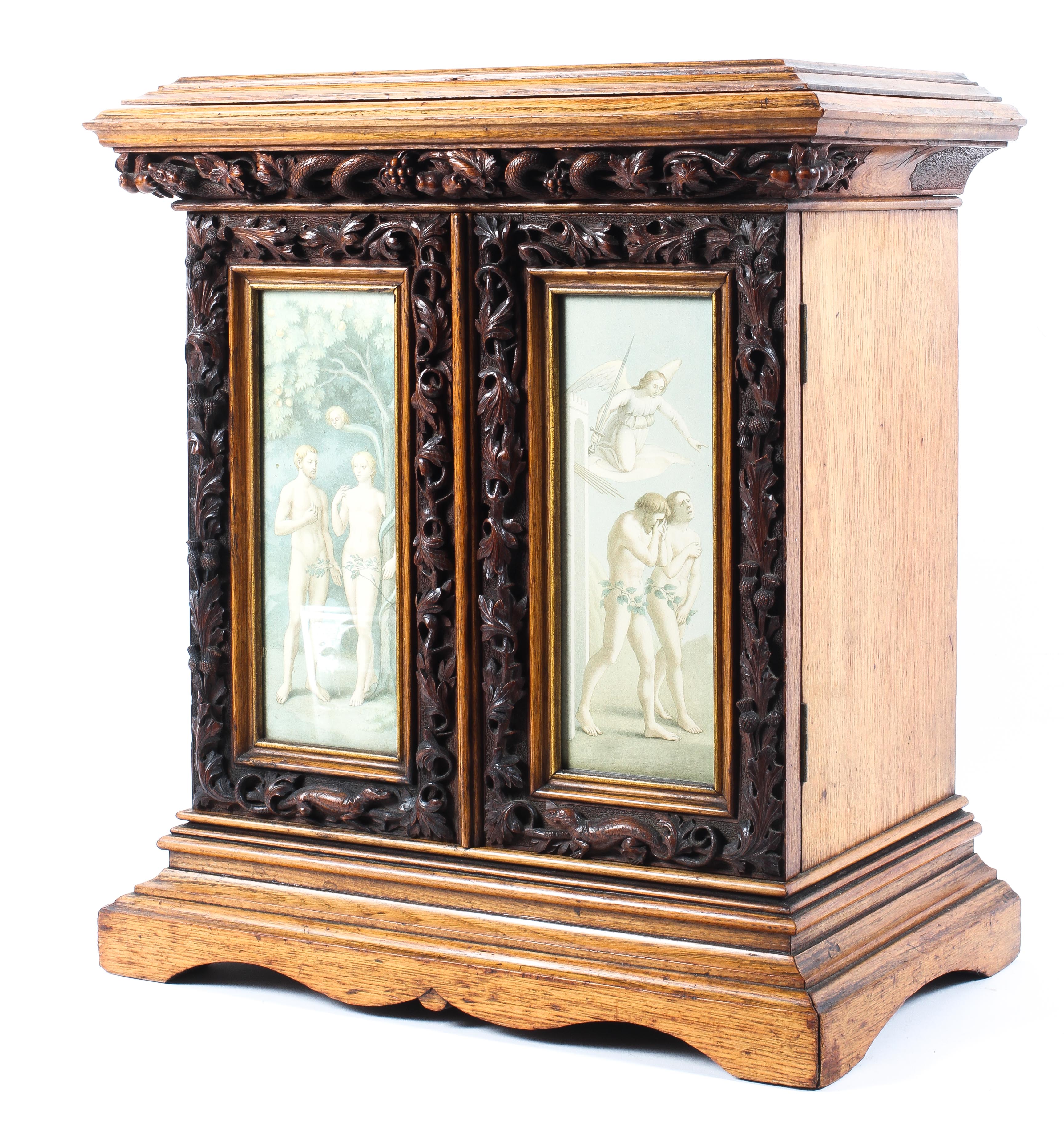 A finely carved early 20th century collector's cabinet with religious theme,