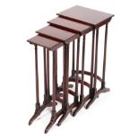 A quartetto nest of mahogany tables on reeded legs and sabre supports, the largest L35.